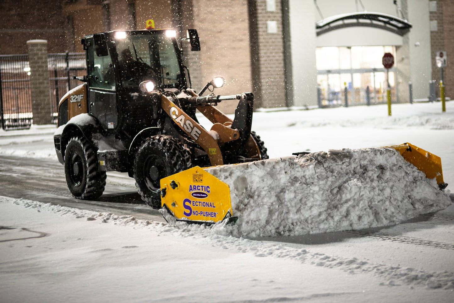 Case snow plow attachment on a vehicle clearing snow in a snowy environment.