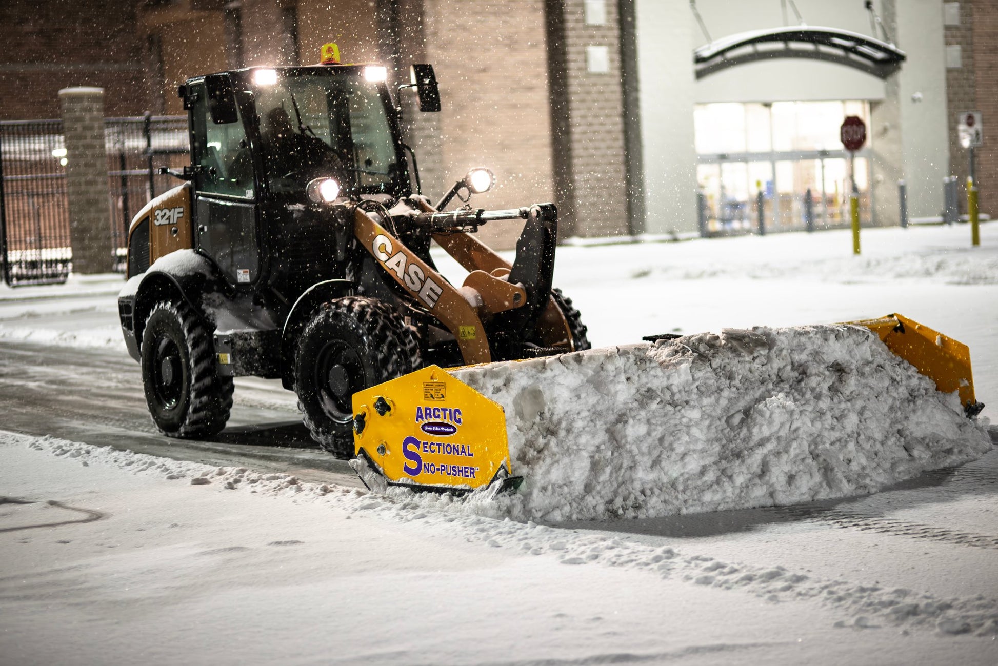 Case snow plow attachment on a vehicle clearing snow in a snowy environment.
